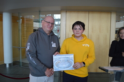 Augustin Lacoursière-Barthe (Youth Parliamentarian MLA Yellowknife North) receiving certificate of participation from Speaker, Honourable Shane Thompson (MLA Nahendeh).