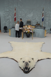 Sumukh Sharma (Youth Parliamentarian MLA Hay River South) next to the Mace. Polar bear rug in foreground.