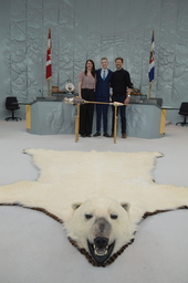 Willem Kanigan (Youth Parliamentarian MLA Dehcho) behind the Mace. Polar bear rug in foreground.