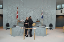 Paige Hawthorn (Youth Parliamentarian MLA Kam Lake) and Harjot Sidhu, Manager, Committees standing behind the Mace.