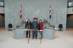 Jacee Mariano (Youth Parliamentarian MLA Range Lake) standing behind the Mace.