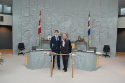 Hunter Groenewegen (Youth Parliamentarian MLA Hay River North) and Jane Groenewegan (grandmother) former Member of the Northwest Territories Legislative Assembly standing behind the Mace.