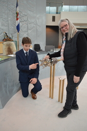 Hunter Groenewegen (Youth Parliamentarian MLA Hay River North) and Jane Groenewegan (grandmother) former Member of the Northwest Territories Legislative Assembly pointing at the diamond in the Mace.